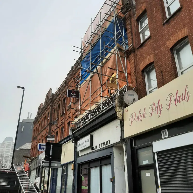 Wide commercial red-brick building with Monarflex sheeting and Devlins board
