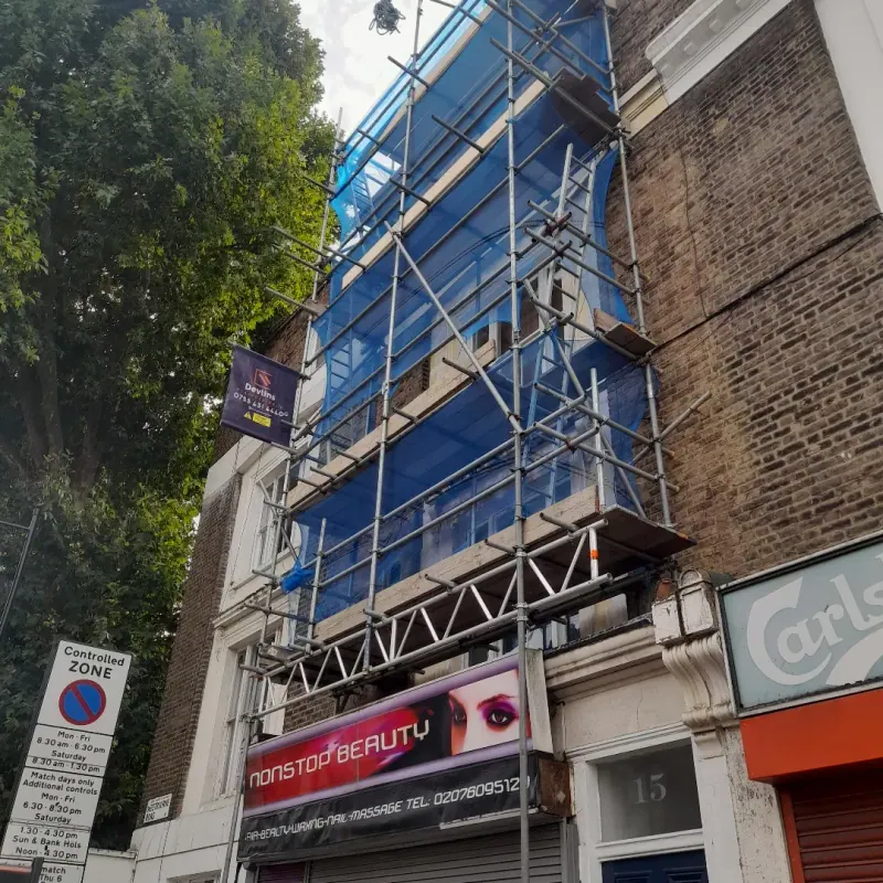 Blue Monarflex encapsulation wrapping a North London shopfront top to bottom