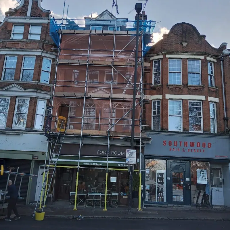 Southwood Lane shopfronts — hair salon and food room with scaffold access