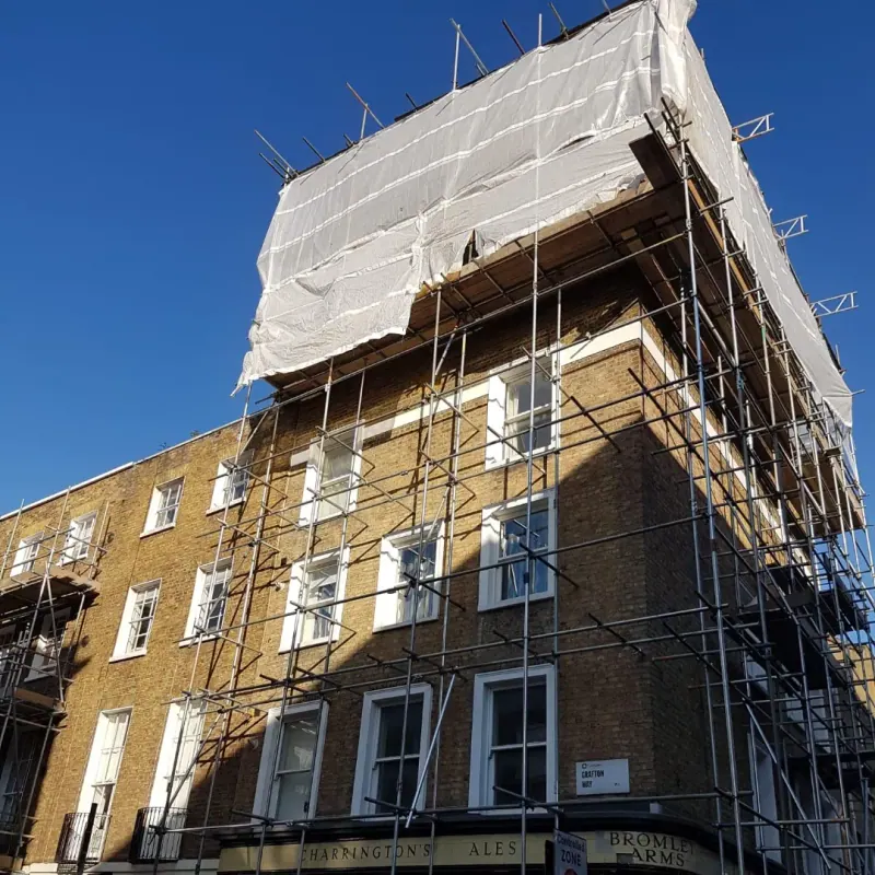 Corner terrace with white encapsulation scaffold under blue sky