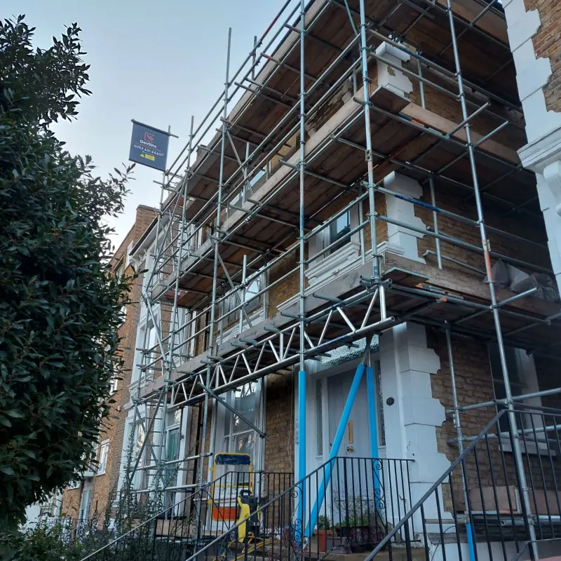 Sunlit Edwardian terrace with front railings, steps and Devlins board
